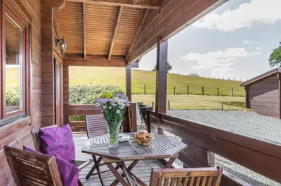 a patio with a table and chairs on a porch at 2 Bed in Llandinam oc-t32993 in Llandinam