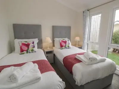 two beds in a room with two windows at Platinum Lodge 503 in Talybont