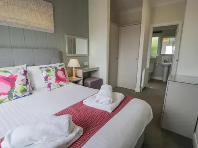 a bedroom with a bed with towels on it at Platinum Lodge 503 in Talybont