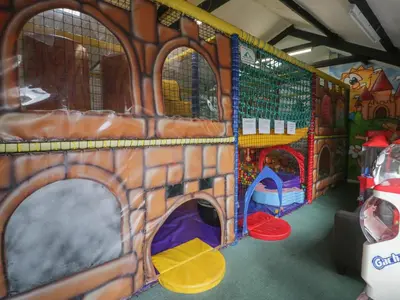 a play room with a toy bus with play equipment at Gold Lodge 201 in Talybont