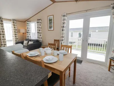 a living room with a table and a couch at Gold Lodge 201 in Talybont