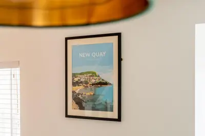 a picture hanging on a wall in a room at Mermaid's Apartment by Ty Annie Holidays in New Quay