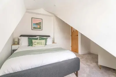 a bedroom with a bed in a attic at Mermaid's Apartment by Ty Annie Holidays in New Quay