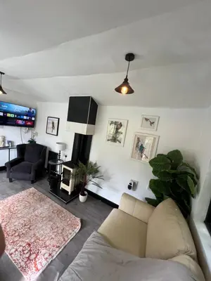 a living room with a couch and a tv at Storeybook cottage in Oswestry