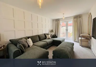 a living room with a couch and a television at 3 Bedroom Home Near Shrewsbury