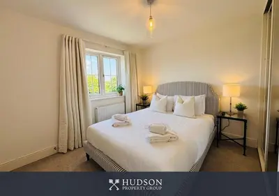 a bedroom with a bed with two towels on it at 3 Bedroom Home Near Shrewsbury