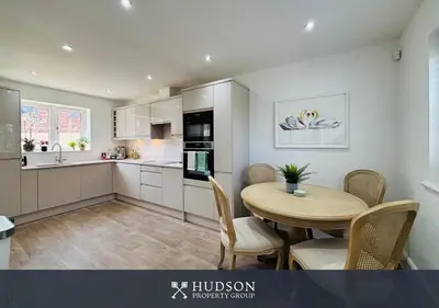 a kitchen with a table and chairs in a room at 3 Bedroom Home Near Shrewsbury