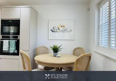 a kitchen with a table and chairs in a room at 3 Bedroom Home Near Shrewsbury