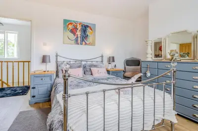 a bedroom with a bed and blue dressers at 3 Bed in Forden oc-c30173 in Forden