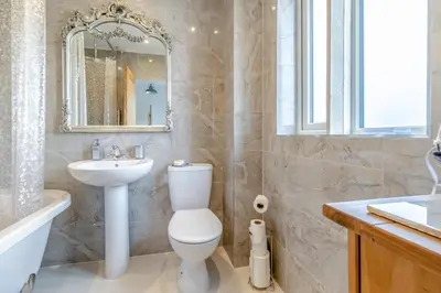 a bathroom with a toilet and a sink and a mirror at 3 Bed in Forden oc-c30173 in Forden