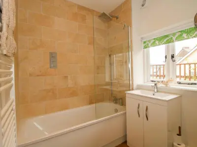 a bathroom with a tub and a sink at 41 High Street in Bishops Castle