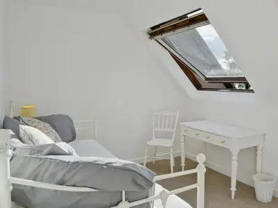 a room with a table and a chair and a mirror at Sisial y Llyn in Bala