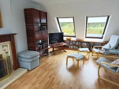 a living room filled with furniture and a tv at Sisial y Llyn in Bala