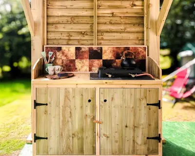 a wooden cabinet with a counter in a yard at Taylor the Burt in Penuwch