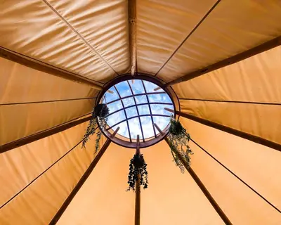 a round window in a yurt with a ceiling at Taylor the Burt in Penuwch