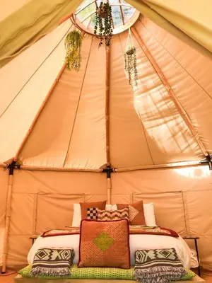 a bed in a tent with pillows in it at Taylor the Burt in Penuwch