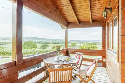 a porch with a table and chairs and a view at 1 Bed in Llandinam oc-t33065 in Llandinam