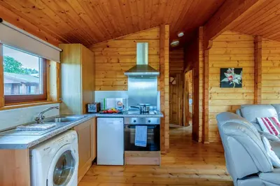 a kitchen with a stove and a washing machine at 1 Bed in Llandinam oc-t33065 in Llandinam