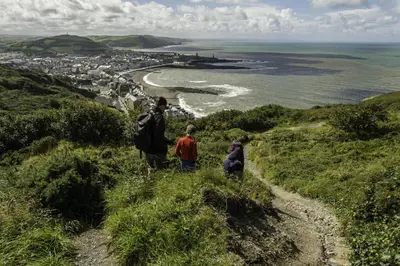 two people standing on a hill looking at the ocean at 1 Bed in Capel Bangor oc-y33024 in Capel Bangor