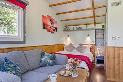 a living room with a couch and a bed at 1 Bed in Llandeilo oc-w33068 in Llanddeusant
