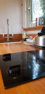 a laptop computer sitting on top of a kitchen counter at The Farm Hut in Barmouth