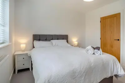 a bedroom with a large bed with two towels on it at 4 Bed in Brecon oc-m32973 in Brecon
