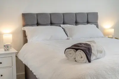 a bed with white sheets and towels on it at 4 Bed in Brecon oc-m32973 in Brecon
