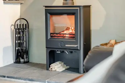 a fireplace with a fire in it in a living room at 3 Bed in Tywyn oc-h32633 in Tywyn