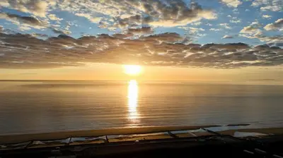 a sunset over the ocean with the sun in the sky at 3 Bed in Tywyn oc-h32633 in Tywyn