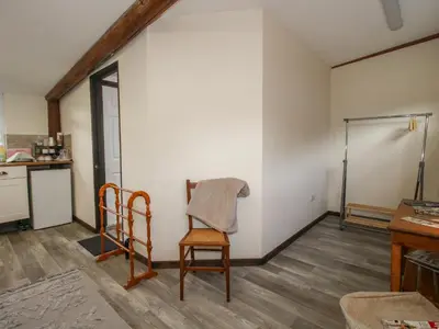 a kitchen with a table and two chairs and a refrigerator at Sharon's Shepherd Hut in Oswestry