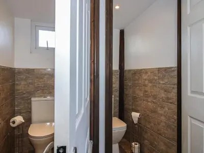 a bathroom with a toilet and a sink at Sharon's Shepherd Hut in Oswestry