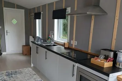 a kitchen with a counter top and a sink at Tranquil Cabin Retreat- Sleeps 2 Parking in Welshpool