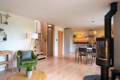 a living room with a kitchen and a dining room at Amberwood Lodge in Hay-on-Wye
