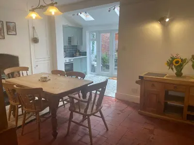 a kitchen and dining room with a wooden table and chairs at Victorian Town House Shrews in Shrewsbury