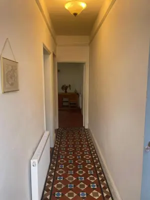 a hallway with a tile floor in a house at Victorian Town House Shrews in Shrewsbury