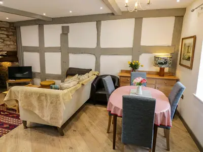 a living room with two tables and a couch at Middle Cottage in Ludlow