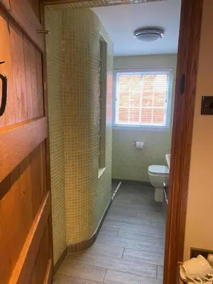 a small bathroom with a toilet and a window at Sebastians in Oswestry