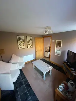 a living room with a couch and a coffee table at Studio Twelve in Brecon