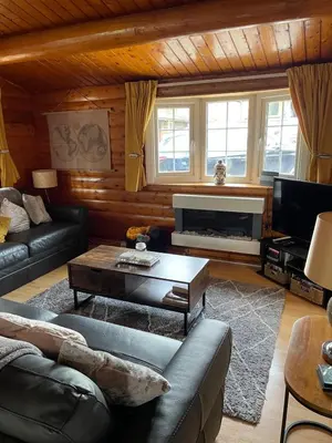 a living room with a couch and a coffee table at IVY Cabin in Trawsfynydd