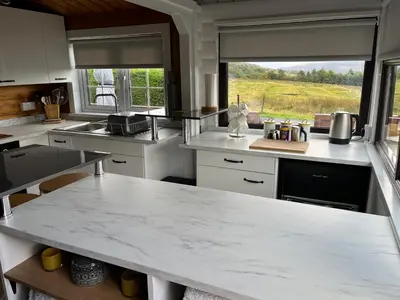 a kitchen with a large white marble counter top at Log Cabin Retreat Snowdonia in Trawsfynydd