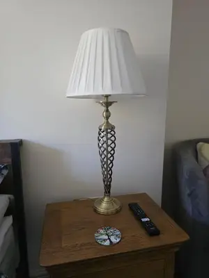 a lamp on a table with a remote control at Family Room - The Unicorn Hotel in Llanidloes