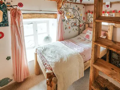 a bedroom with a bunk bed and a window at Ty Fferm Bargoed in Aberaeron