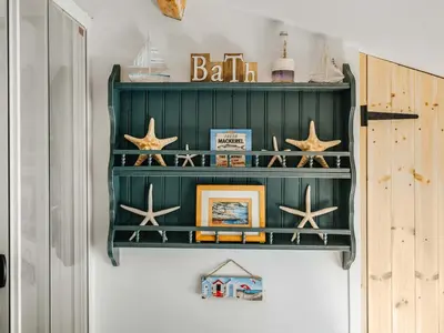 a green shelf with stars on a wall at Ty Fferm Bargoed in Aberaeron