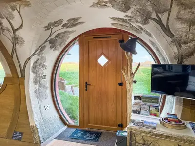 a room with a door with a painting on the wall at Shires End in Leominster