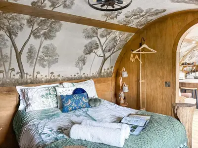 a bedroom with a bed with a wall mural at Shires End in Leominster