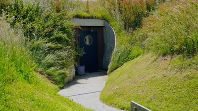 a blue door in the middle of a path at The Willow Hill in Aberdyfi