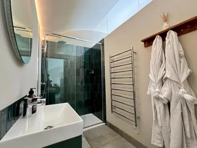 a bathroom with a sink and a shower at The Willow Hill in Aberdyfi