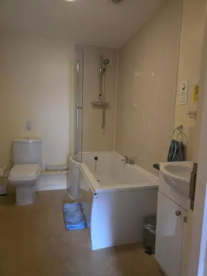 a bathroom with a tub and a toilet and a sink at Honeymoon Suite - The Unicorn Hotel in Llanidloes