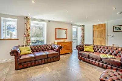 two brown leather couches in a living room at 3 Bed in Defynnog oc-p33133 in Devynock