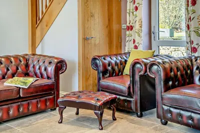two leather chairs and a couch and a stool at 3 Bed in Defynnog oc-p33133 in Devynock